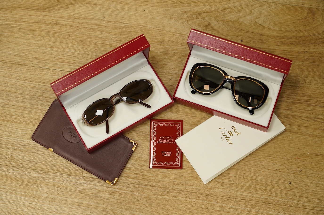 Two pairs of Must de Cartier sunglasses